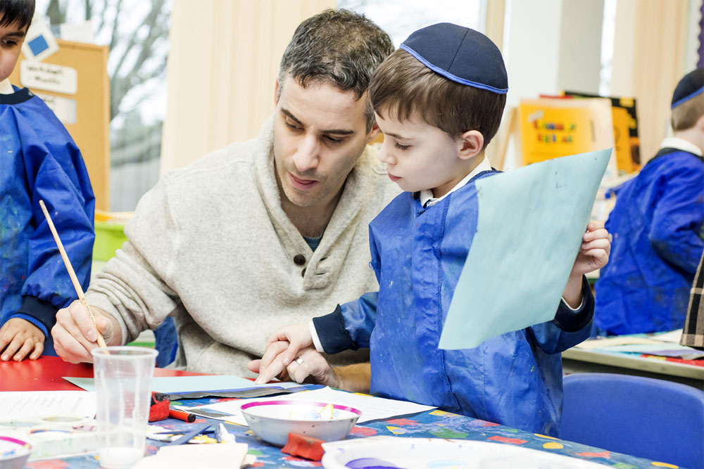 Young boy with an adult painting